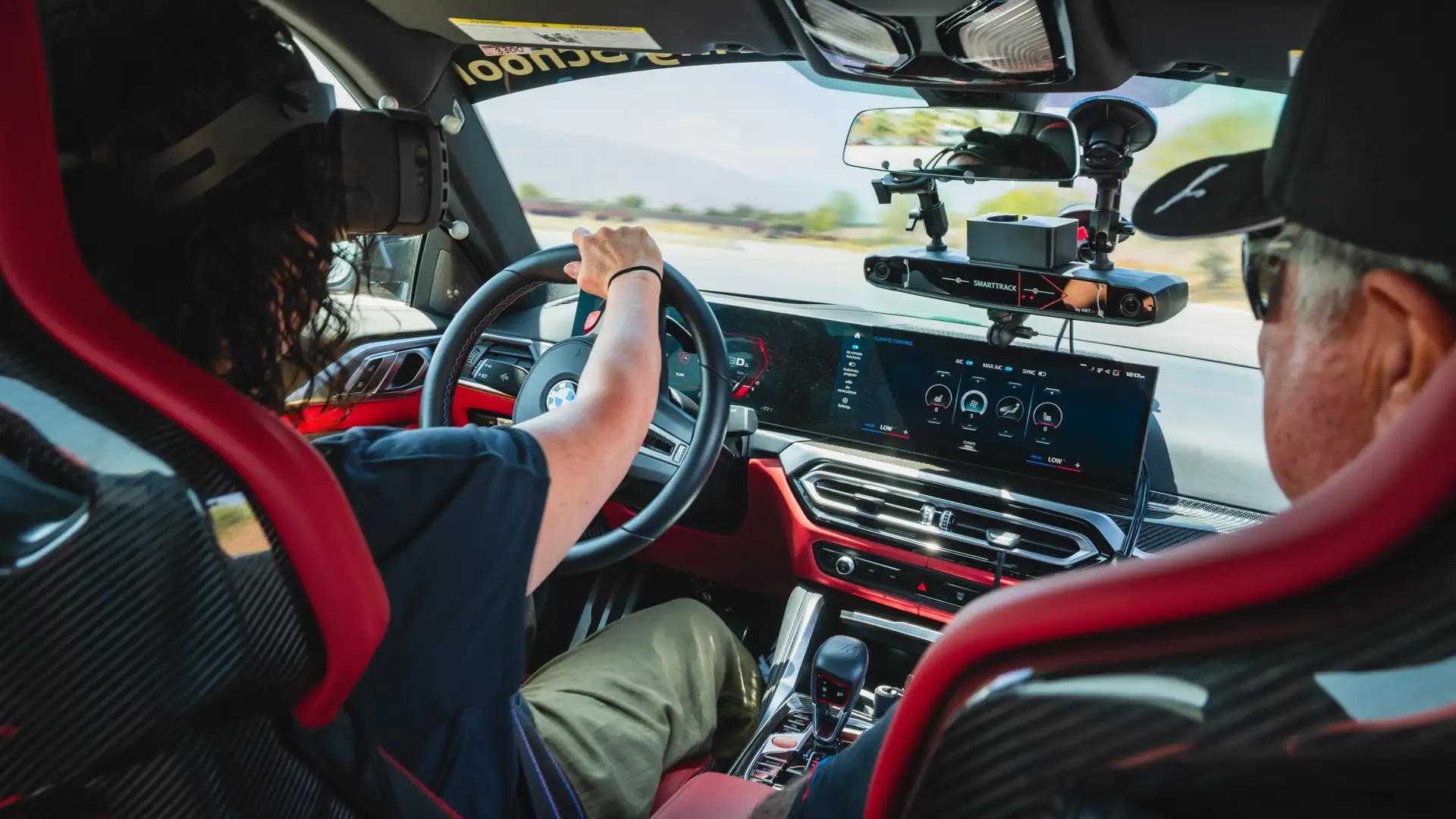 Driver and instructor in a camera-equipped BMW M car on track