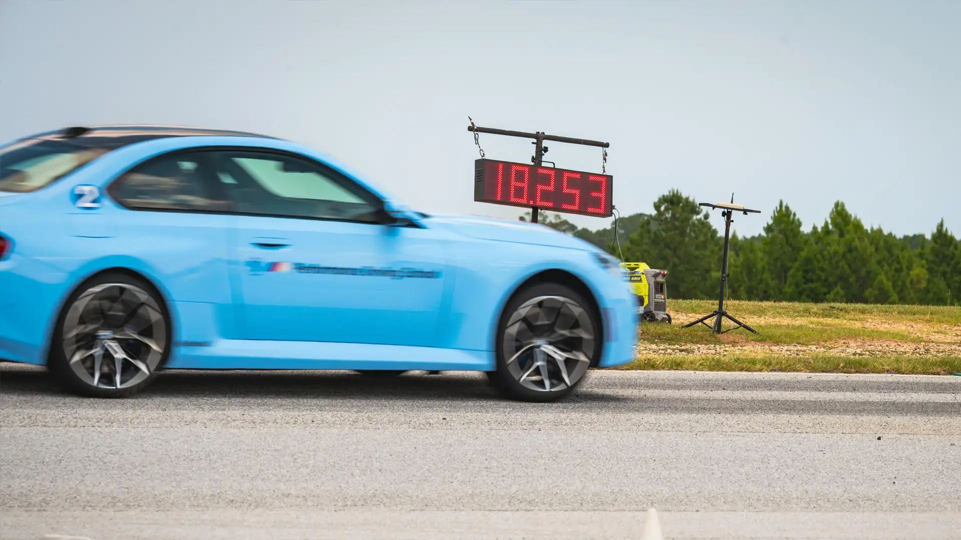 Light blue BMW M2 crossing the line as the timer reads 18.253