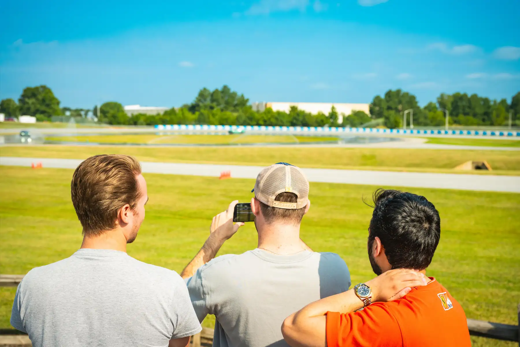 Participants watching and filming the action from trackside