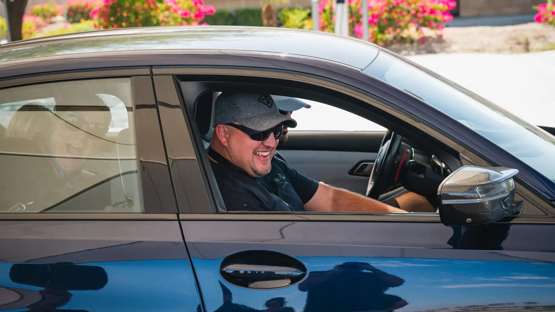 Laughing participant in the passenger seat after a hot lap