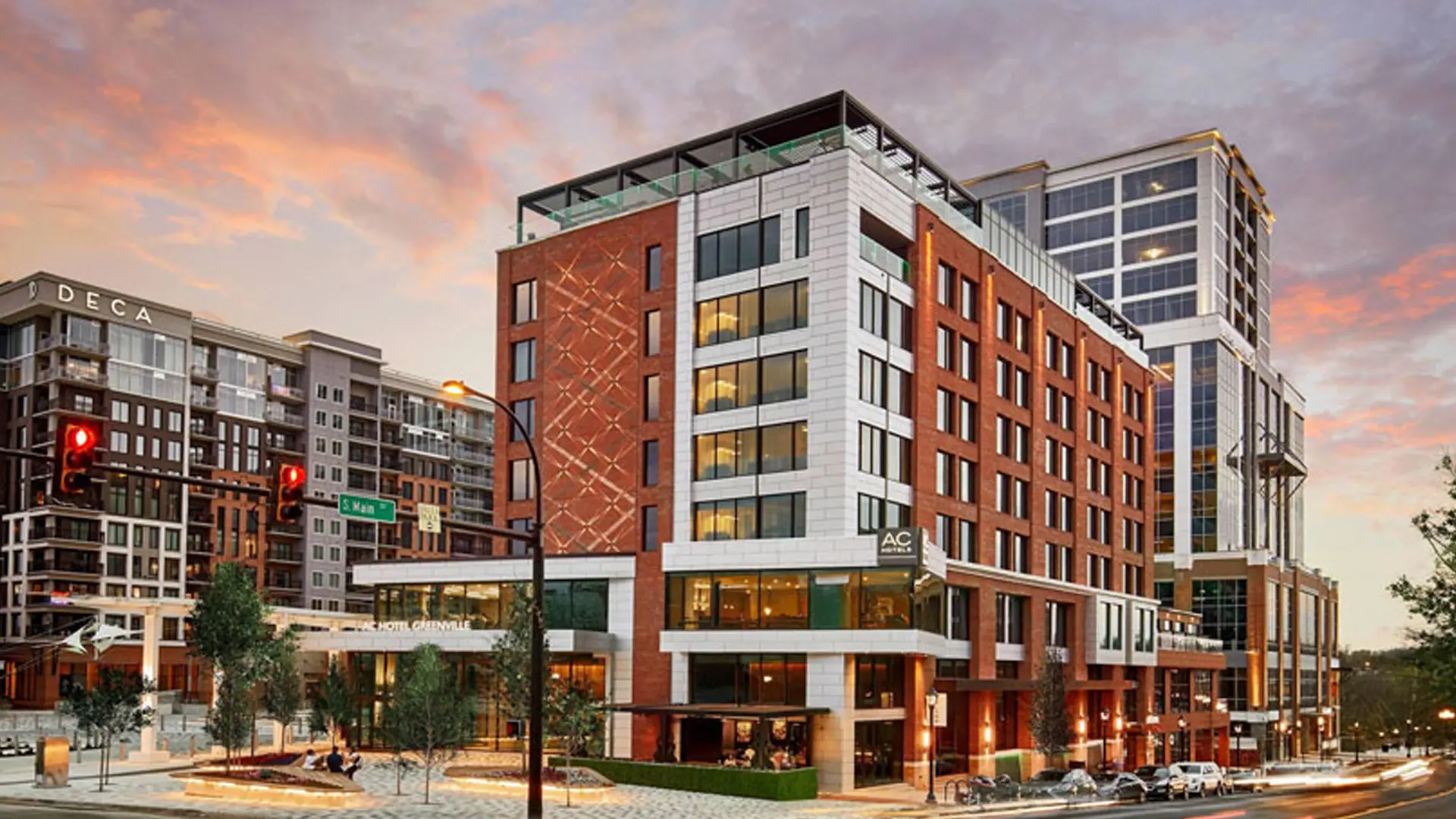 AC Hotel Greenville on the corner at sunset