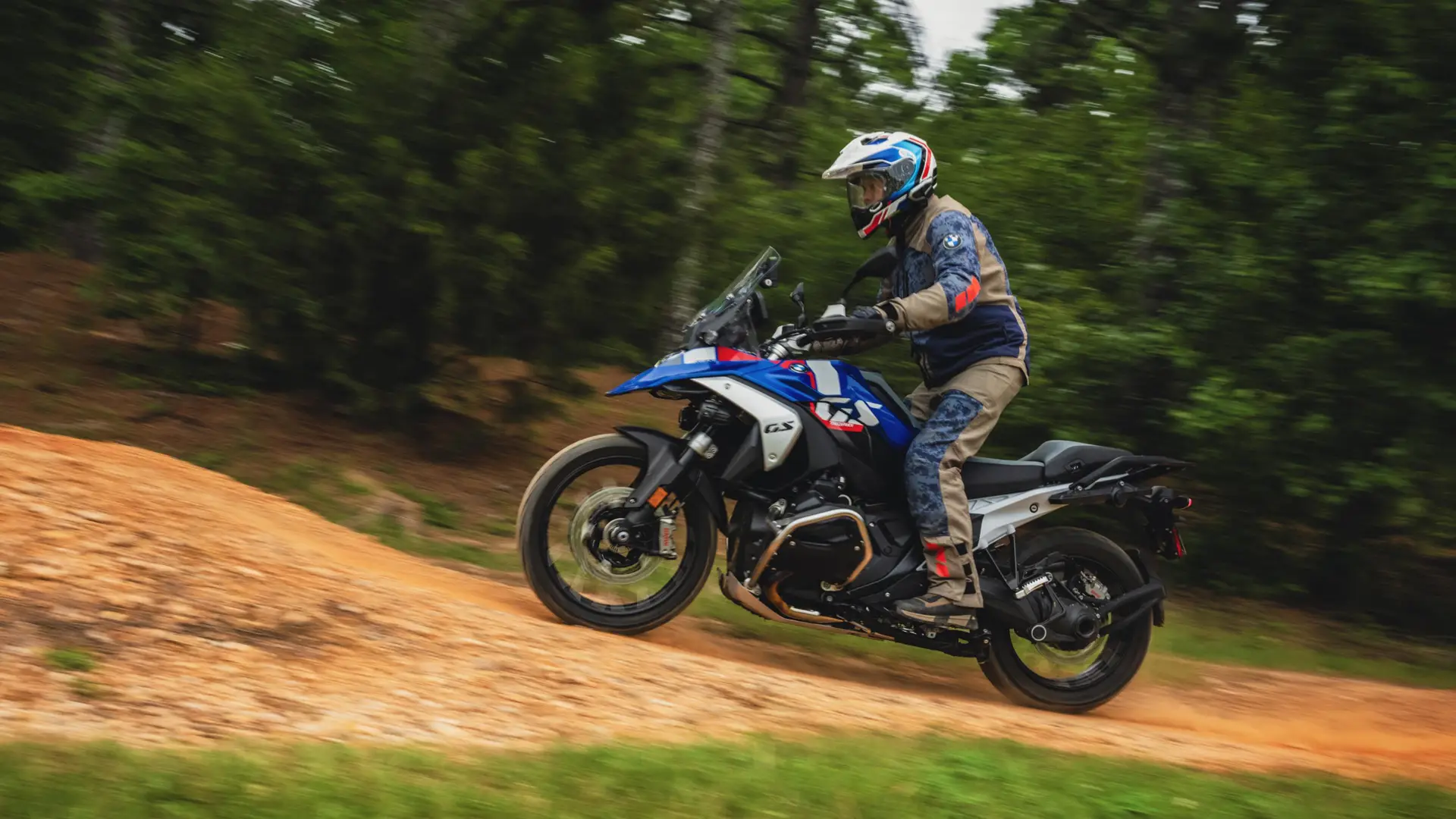 Rider climbing a dirt slope on a BMW GS