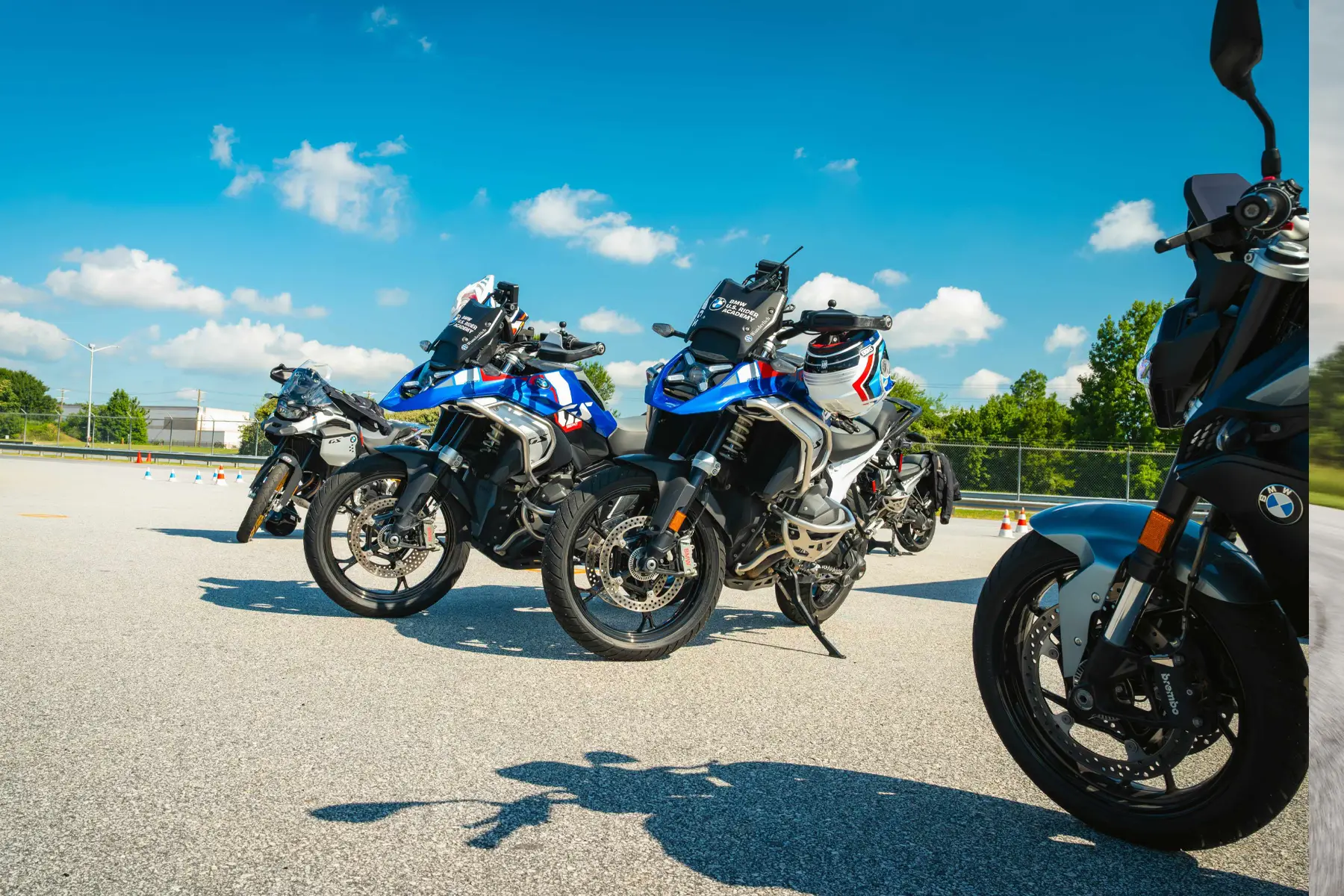 BMW GS motorcycles parked with helmets resting on the seats