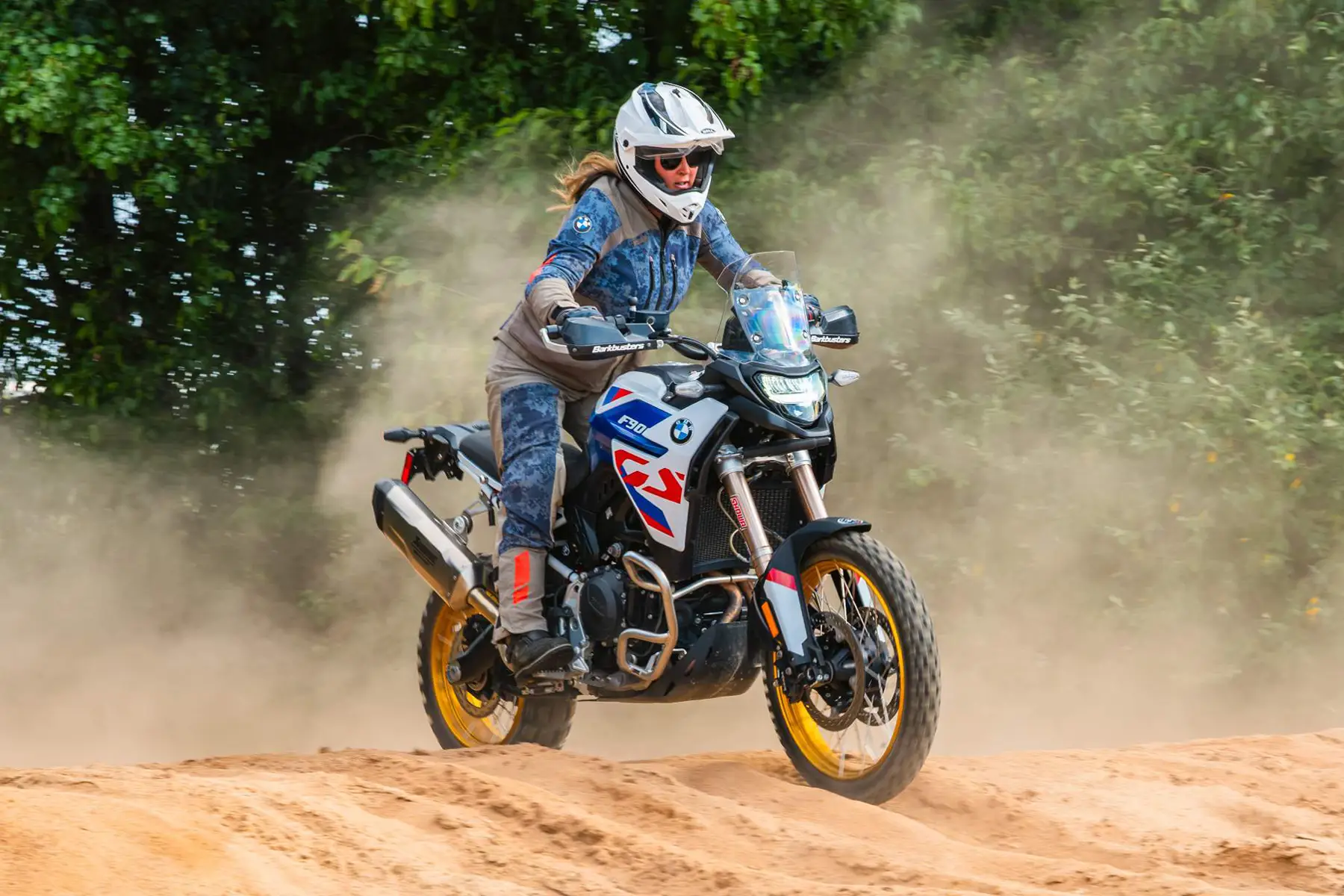 Rider cresting a sand berm on a BMW F 900 GS