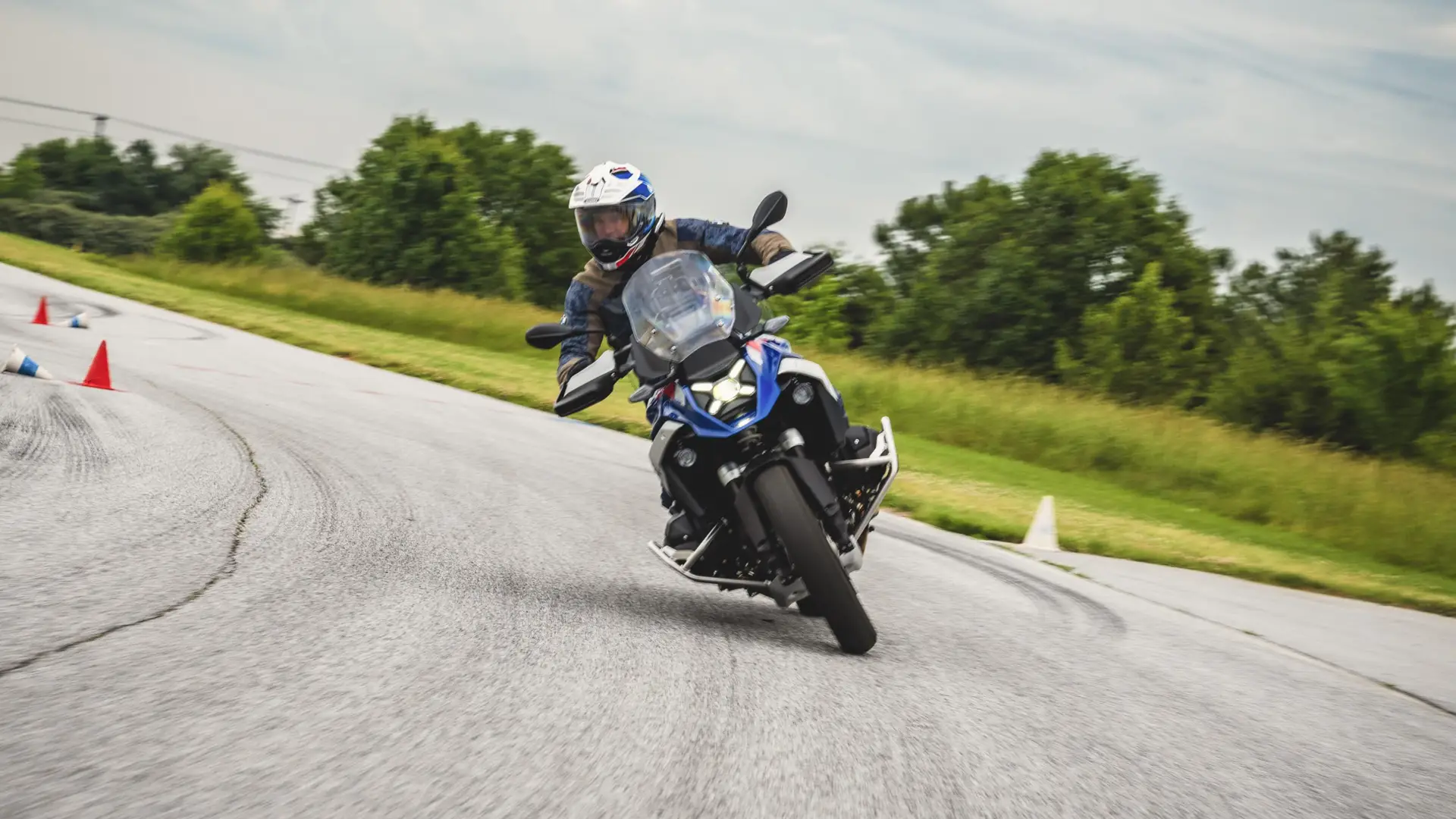 Rider leaning a BMW GS through a bend on the skills course