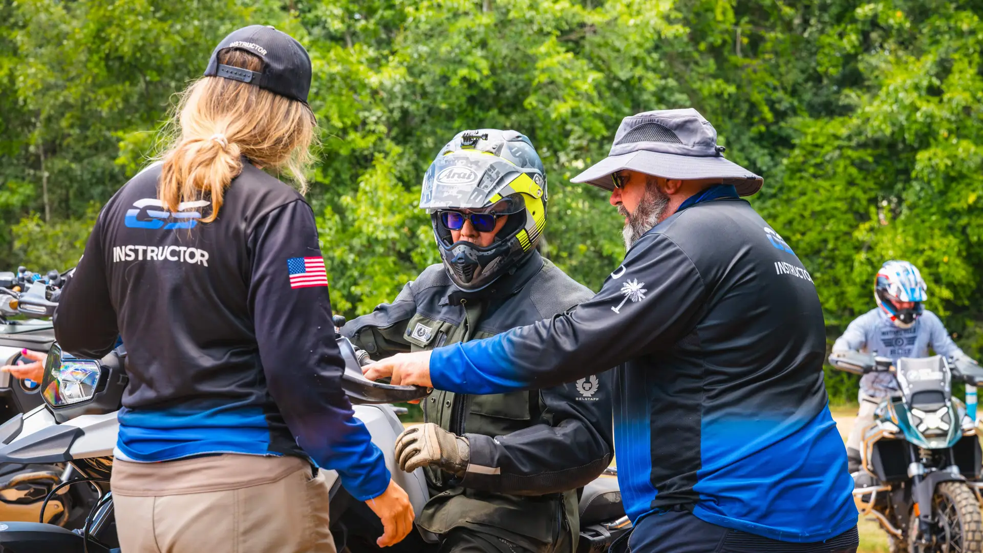 Two instructors briefing a rider at the off-road course