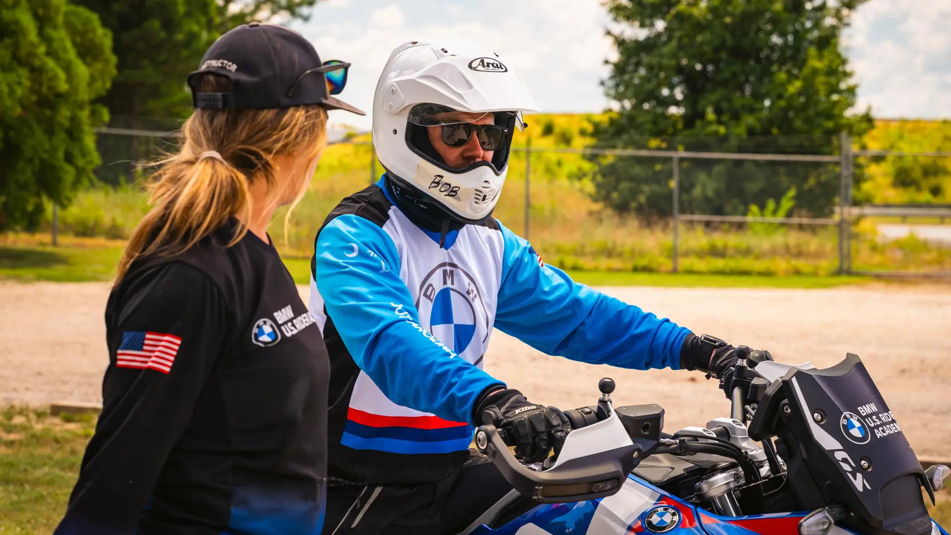 Instructor talking with a rider seated on a BMW GS