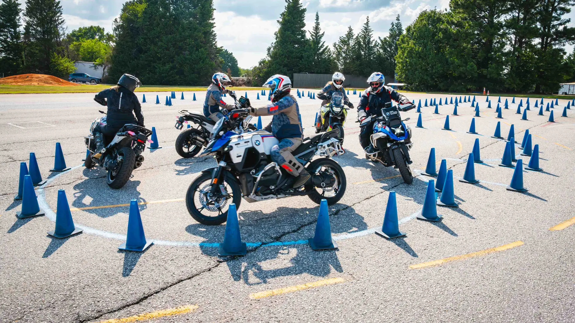 Riders gathered inside a circle of cones on the training pad