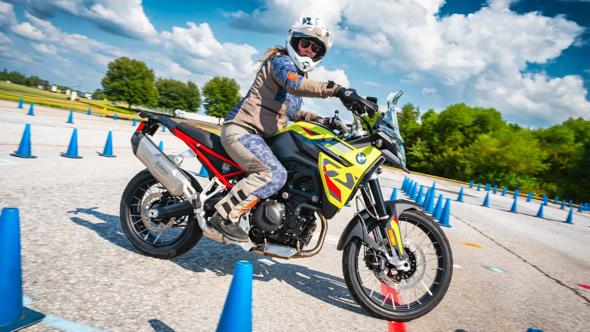 Rider on a yellow BMW F 900 GS weaving through cones