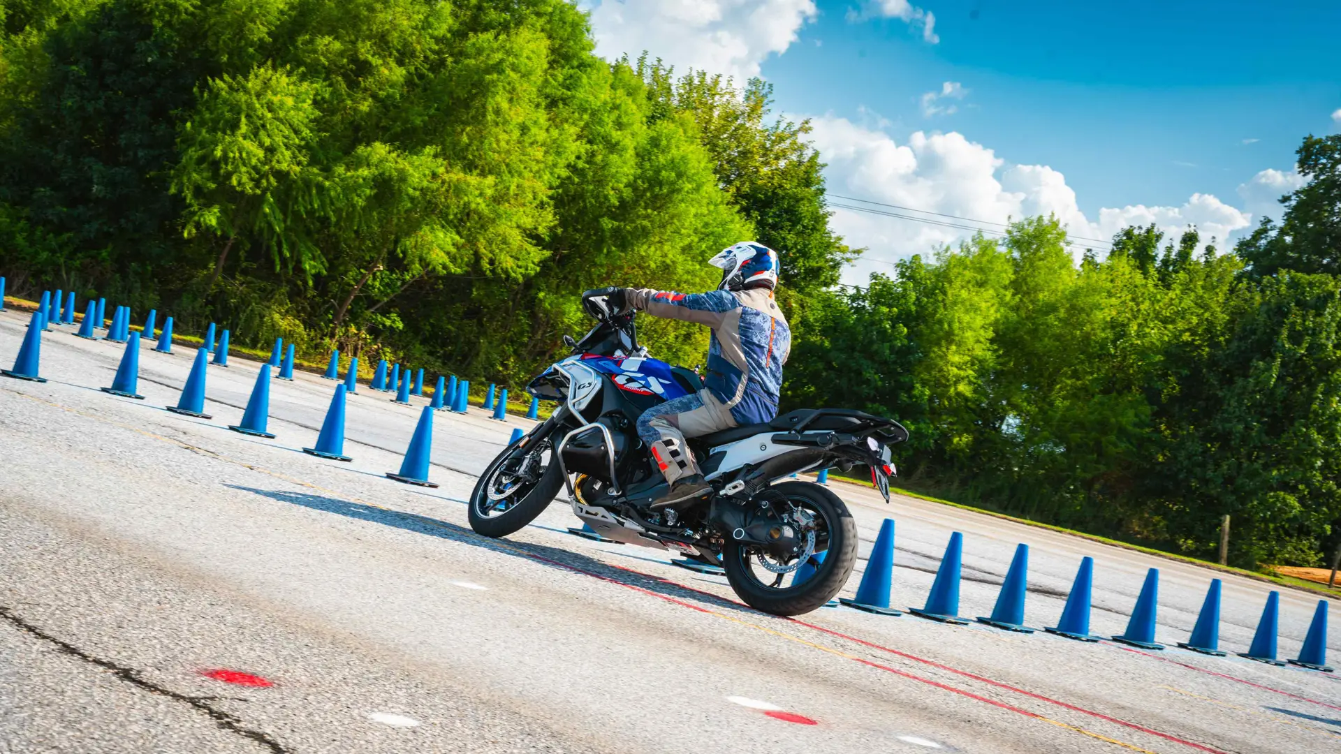 Rider leaning a BMW GS through a long line of cones