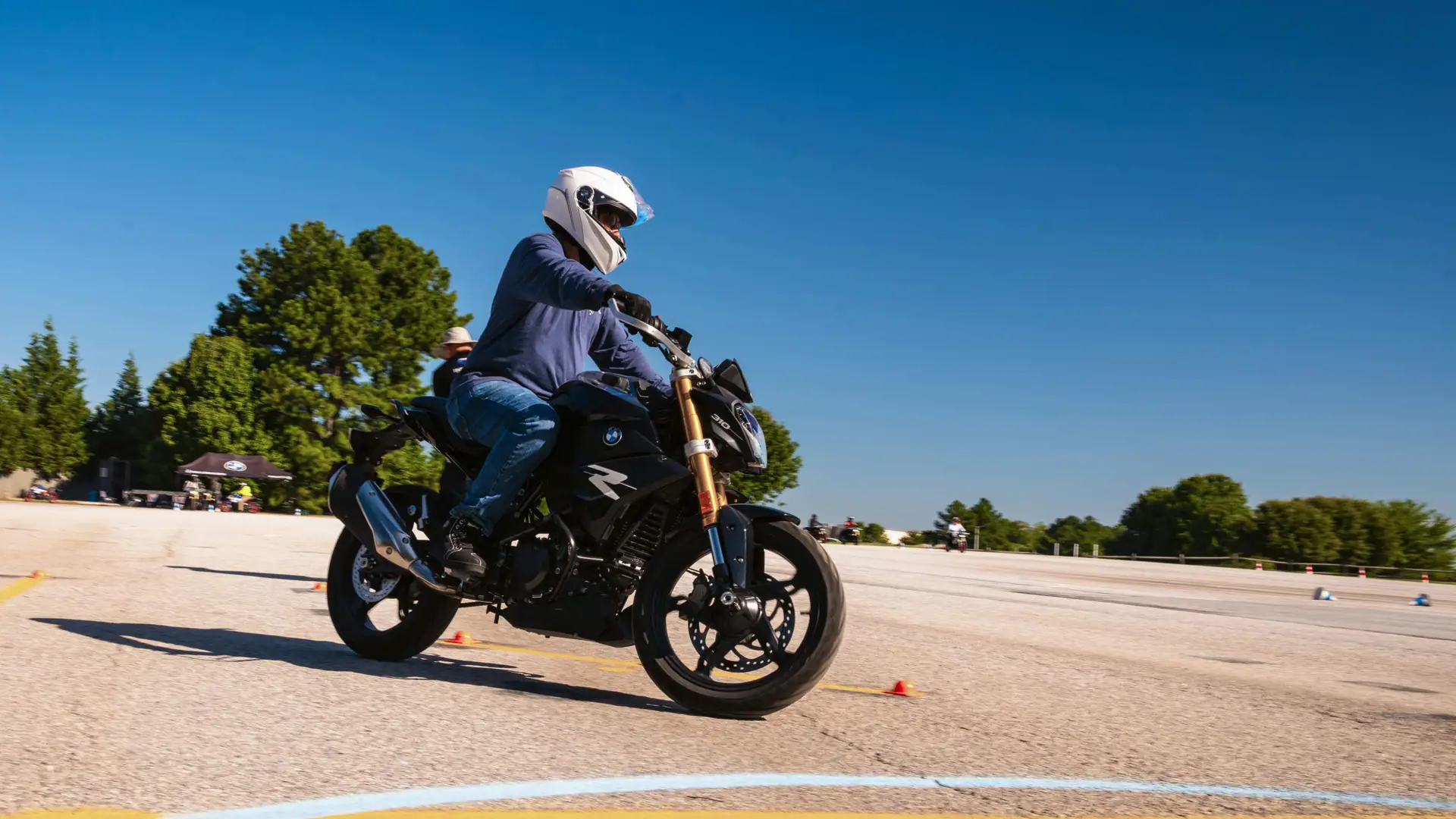 Rider leaning a BMW G 310 R around a painted turning circle