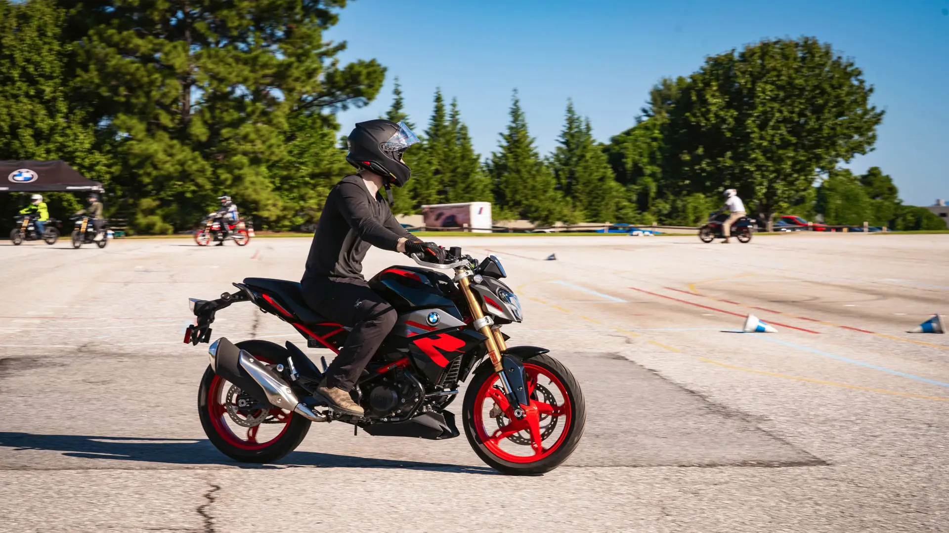 Rider on a BMW G 310 R on the training pad during a safety course