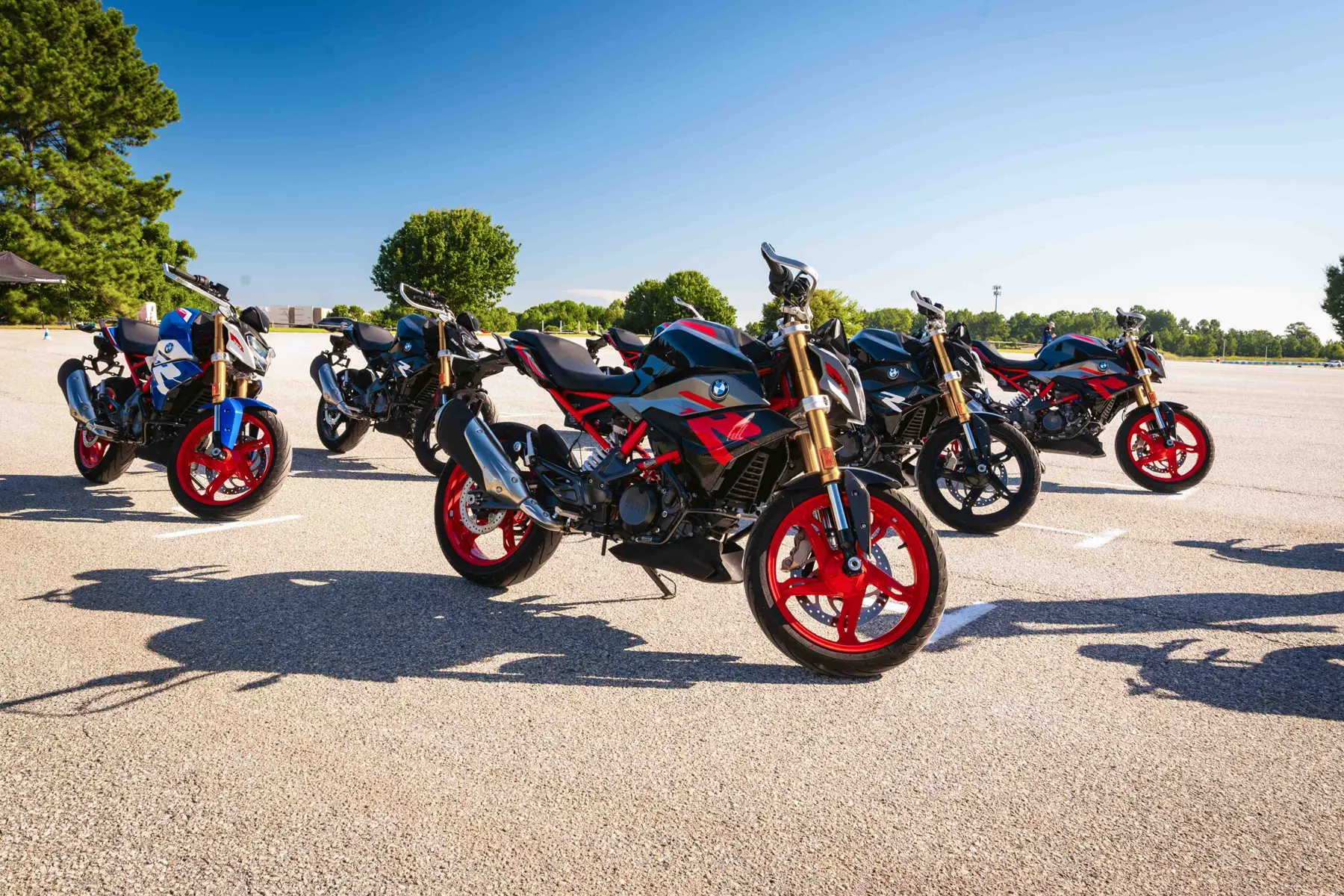Row of BMW G 310 R motorcycles lined up on the training pad