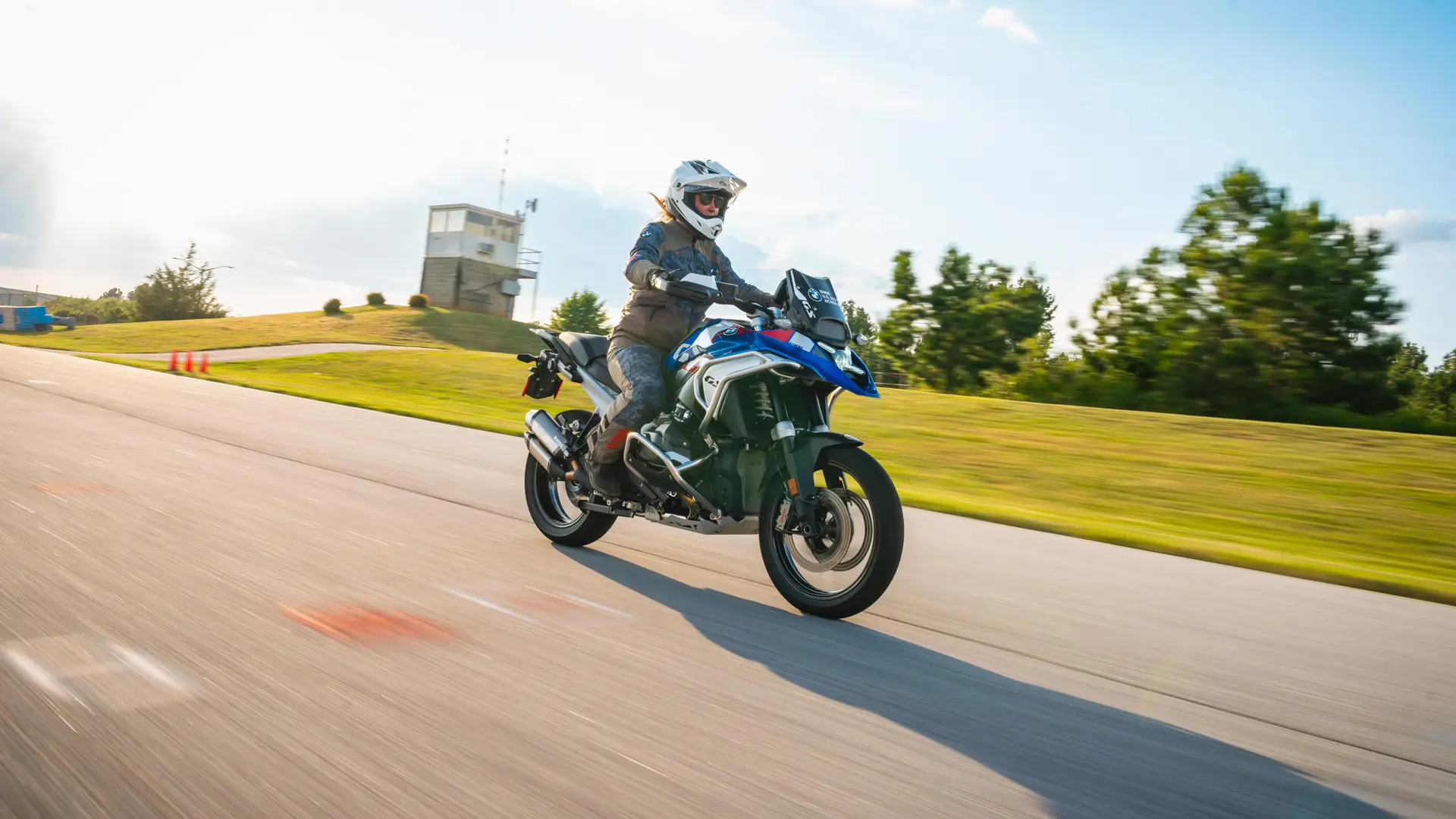 Rider on a BMW GS accelerating past the control tower