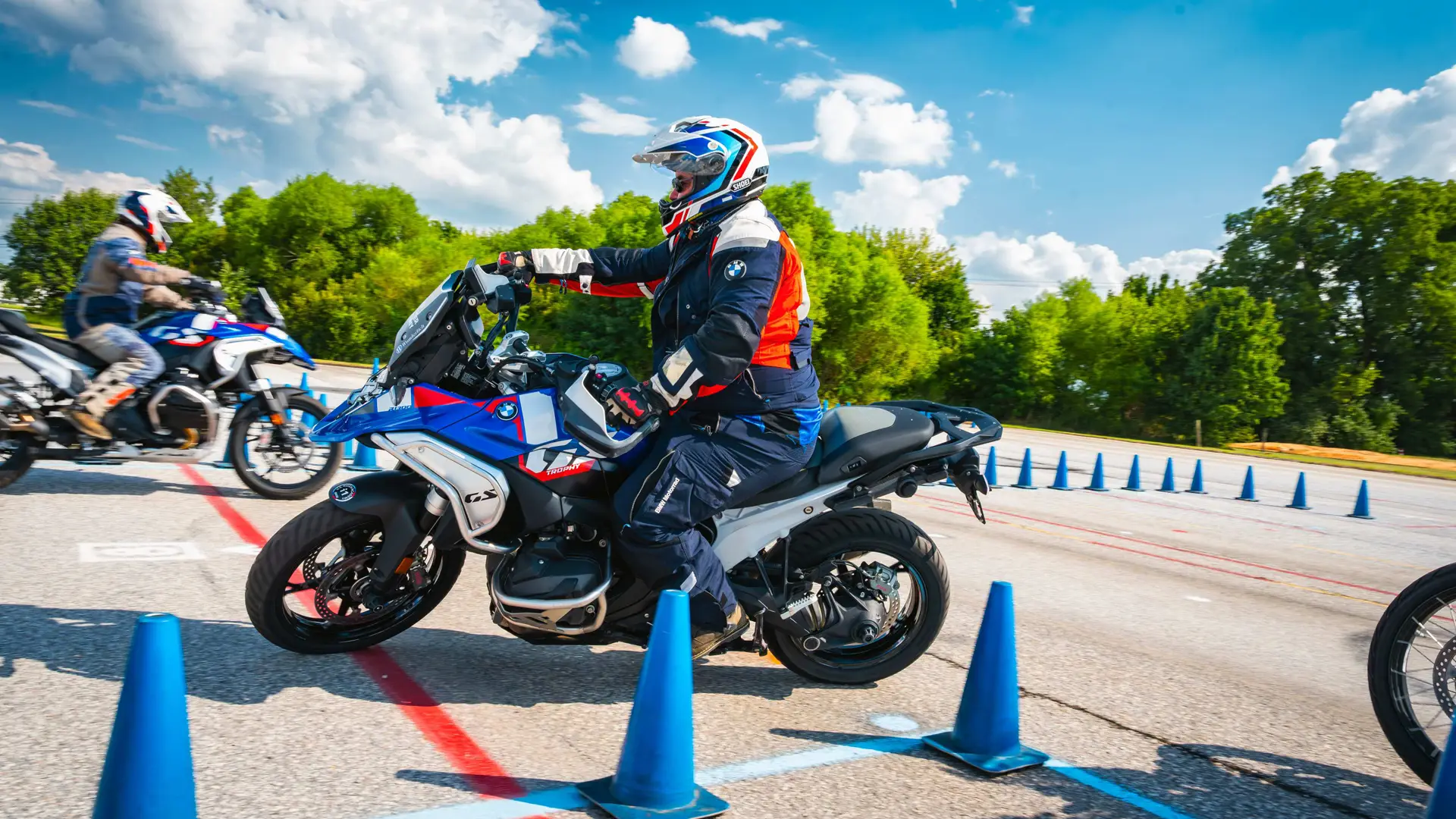 Rider steering a BMW GS slowly between cones