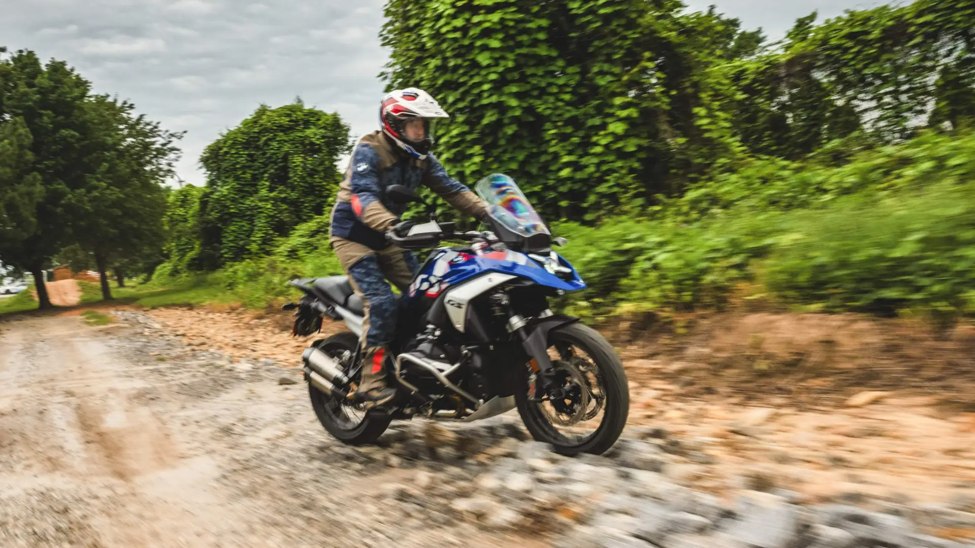 Rider on a BMW GS riding a loose gravel trail