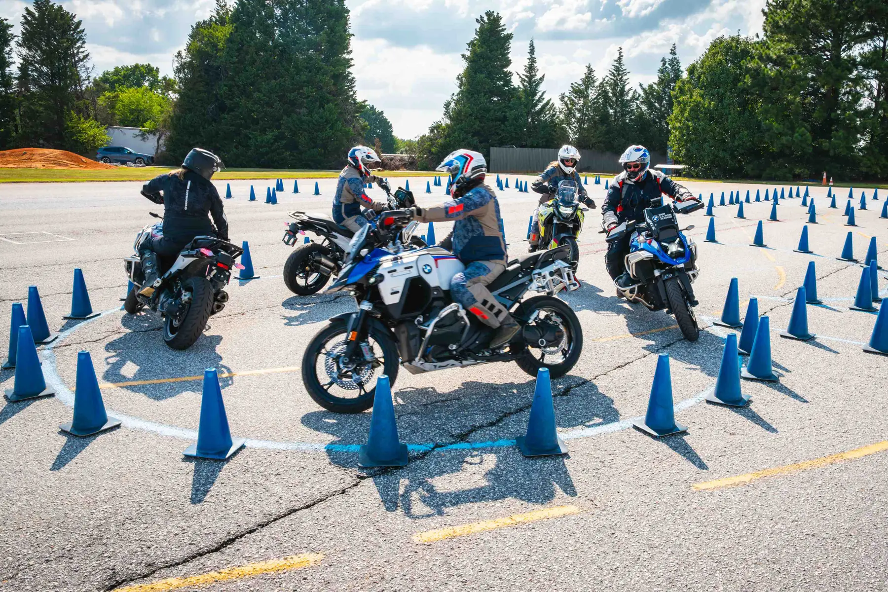 Group of riders gathered inside a circle of cones for a briefing