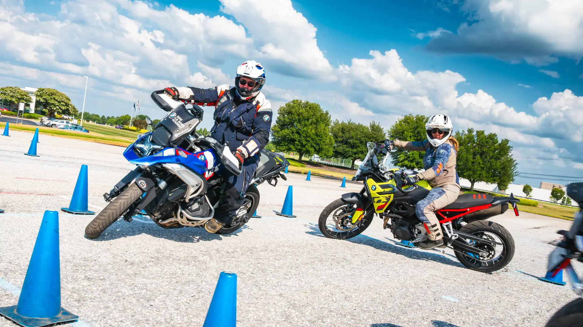 Rider leaning a BMW GS deep into a turn through a cone course