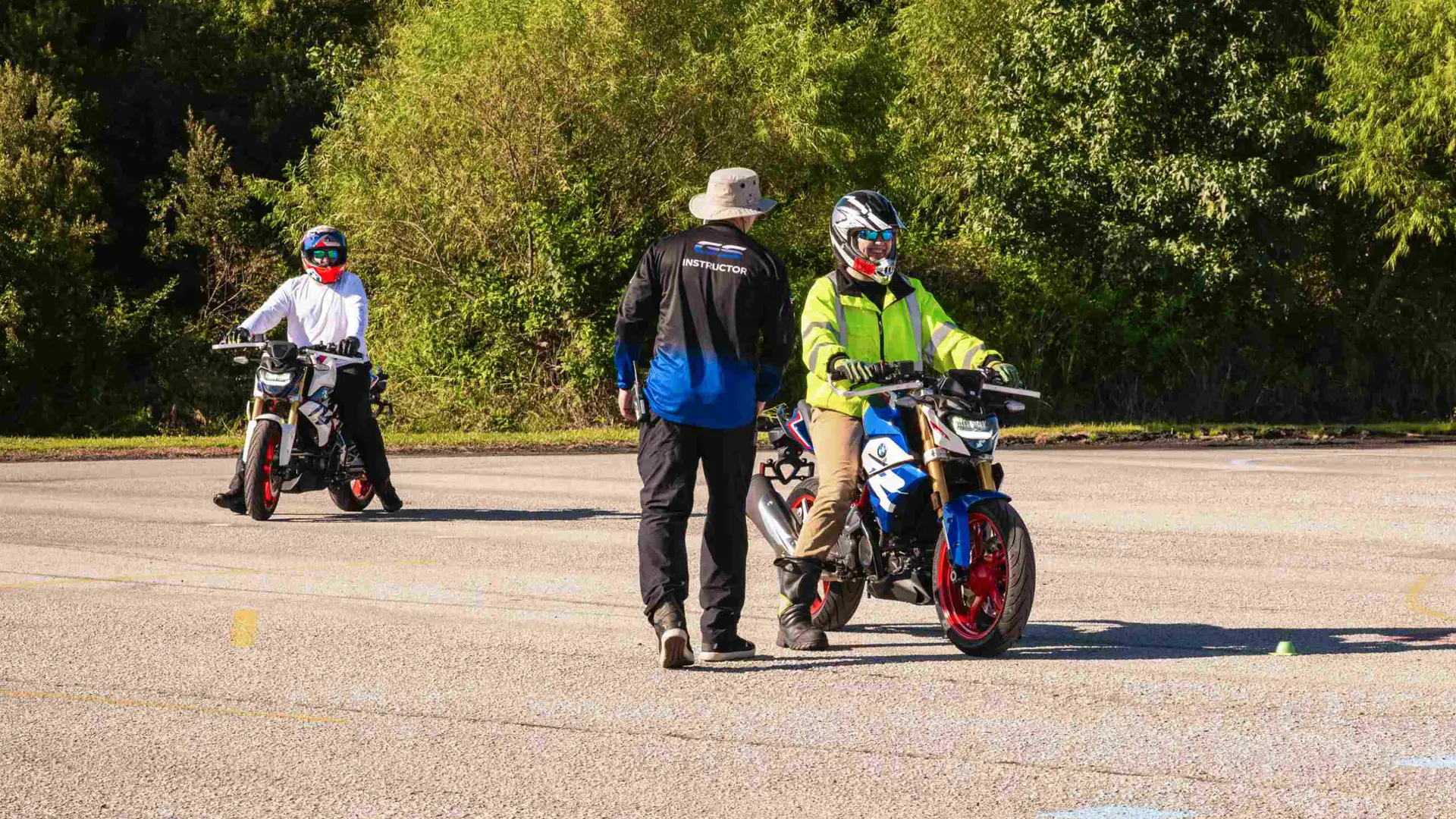 Instructor working with two learners on the training pad