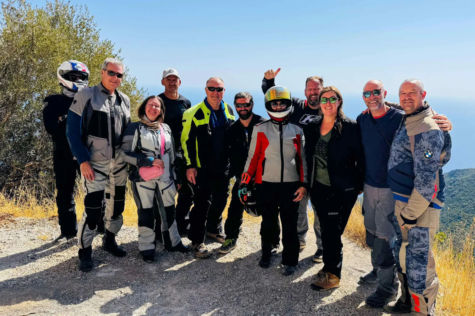 Tour group posing together at a hilltop viewpoint in Sicily