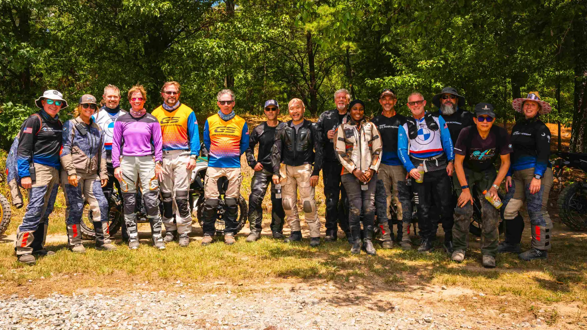 Group of riders in adventure gear posing together at the off-road course