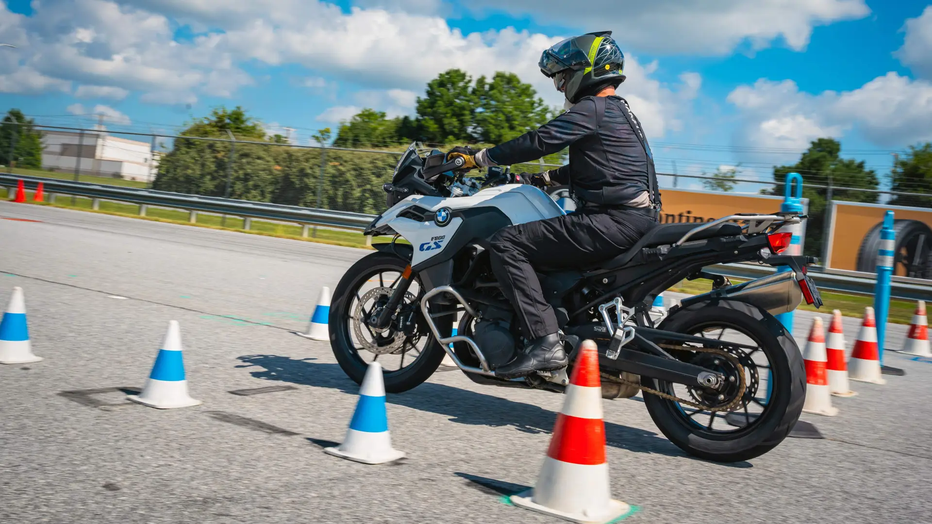 Rider threading a BMW F 900 GS between cones