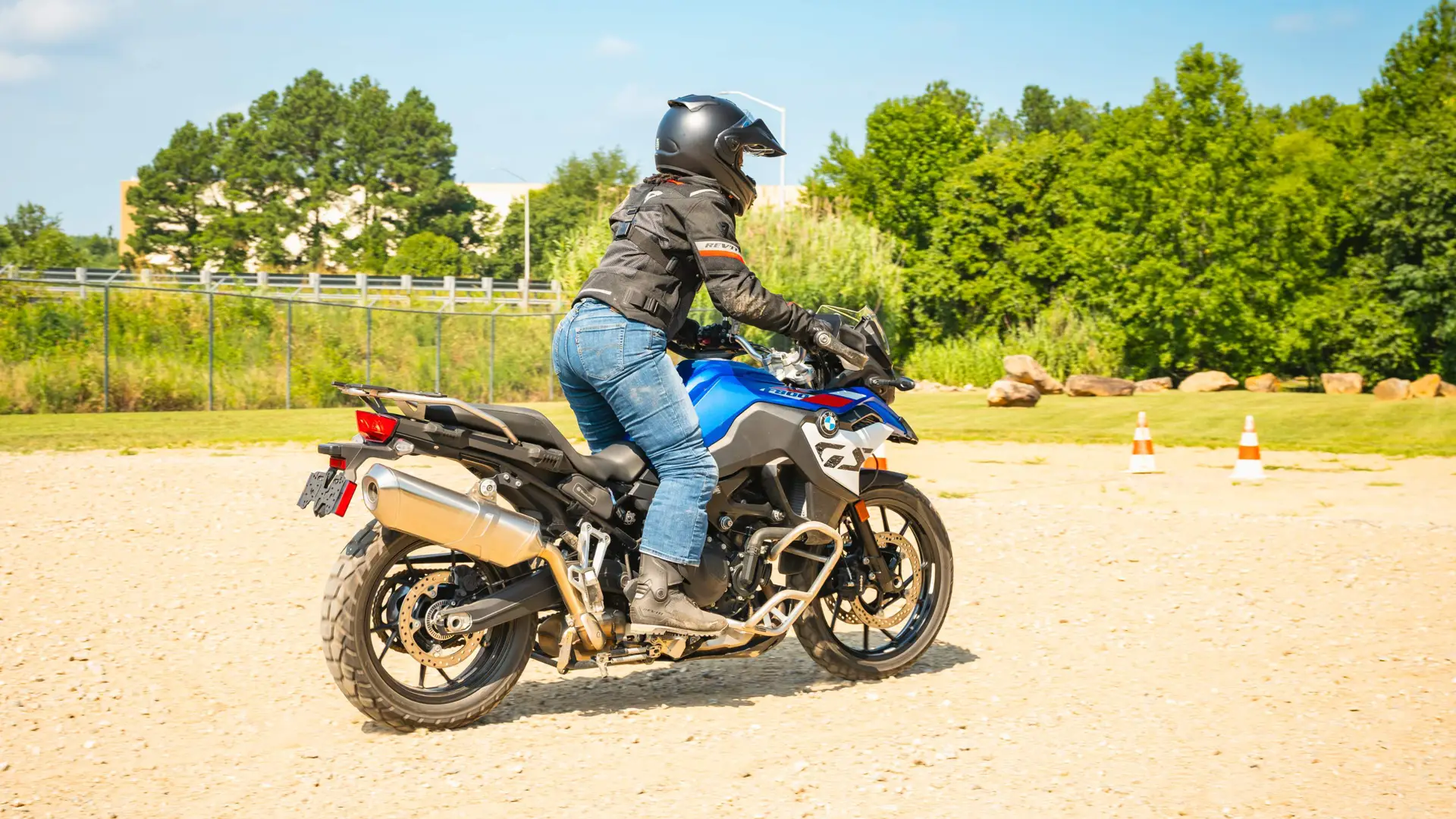 Rider standing on the pegs of a BMW F 900 GS at low speed