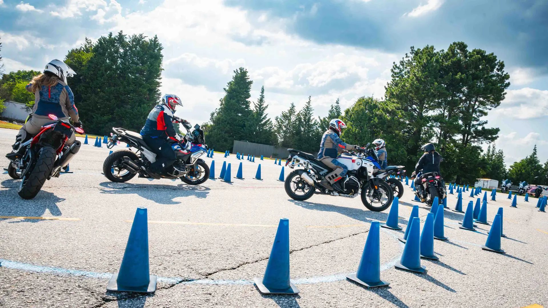 Riders working through a blue cone pattern on the training pad