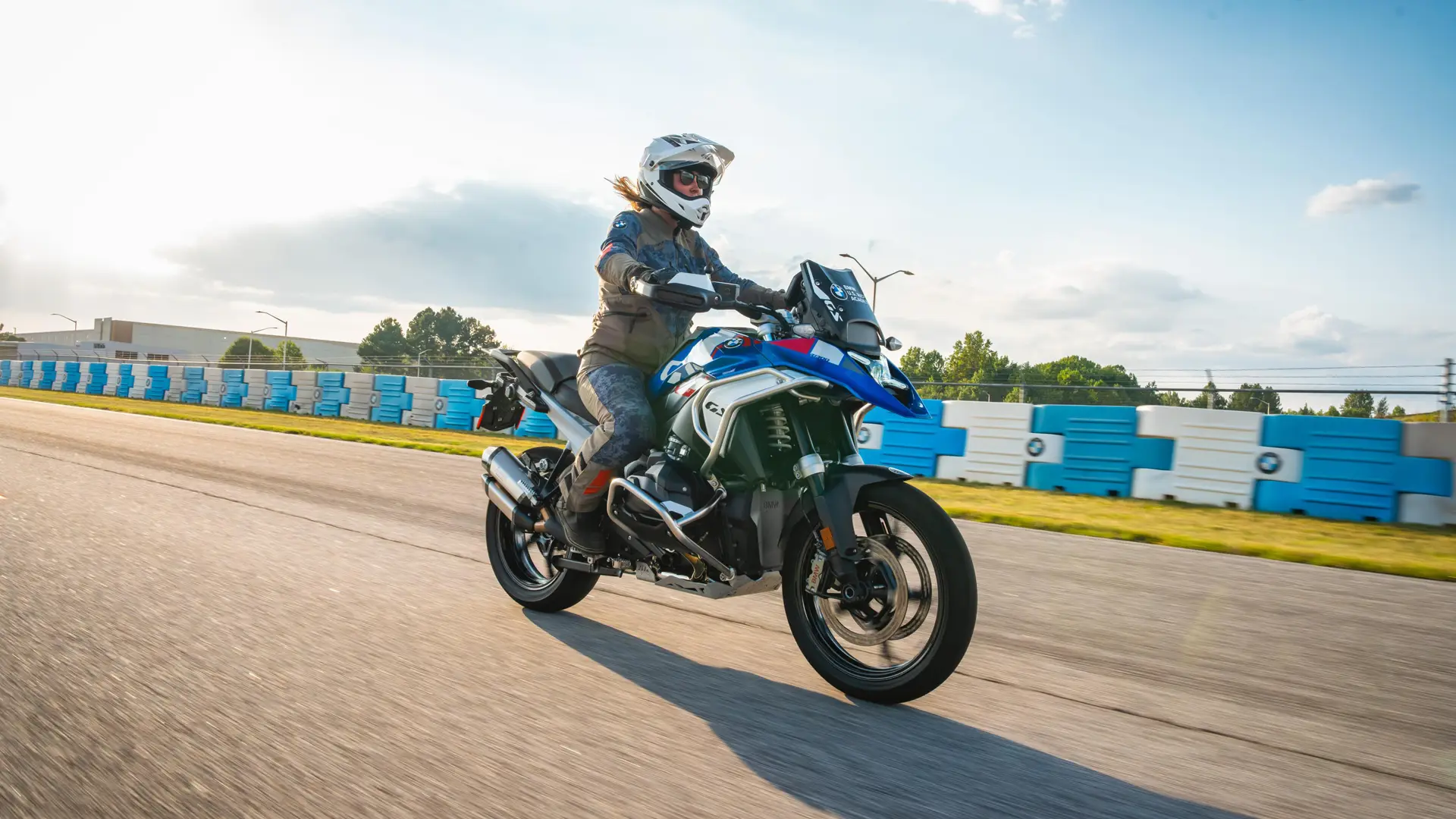 Rider on a BMW GS riding the paved circuit past BMW barriers