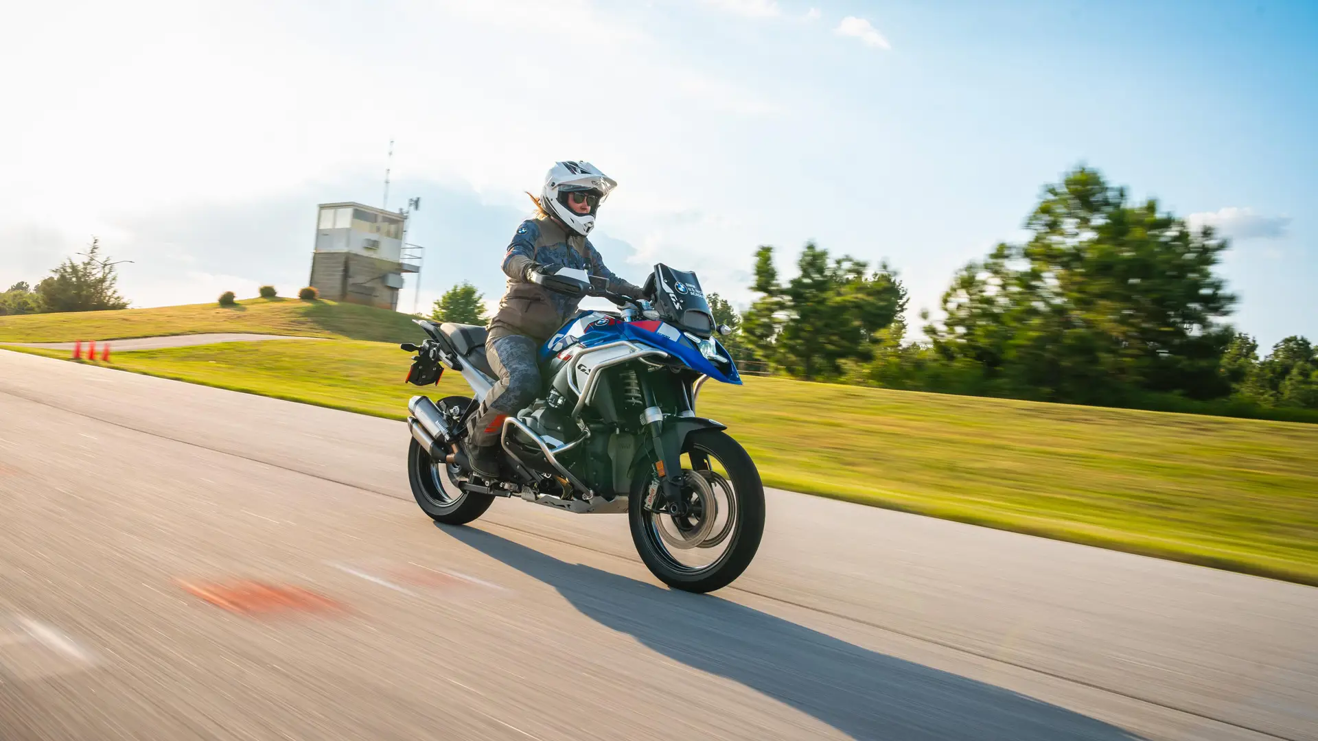 Rider on a BMW GS accelerating along the paved riding course