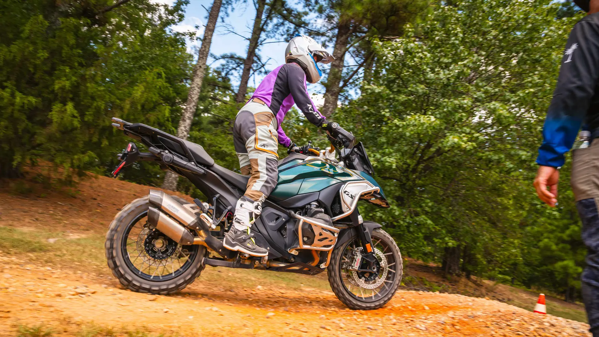 Rider standing on the pegs of a BMW GS over rutted ground