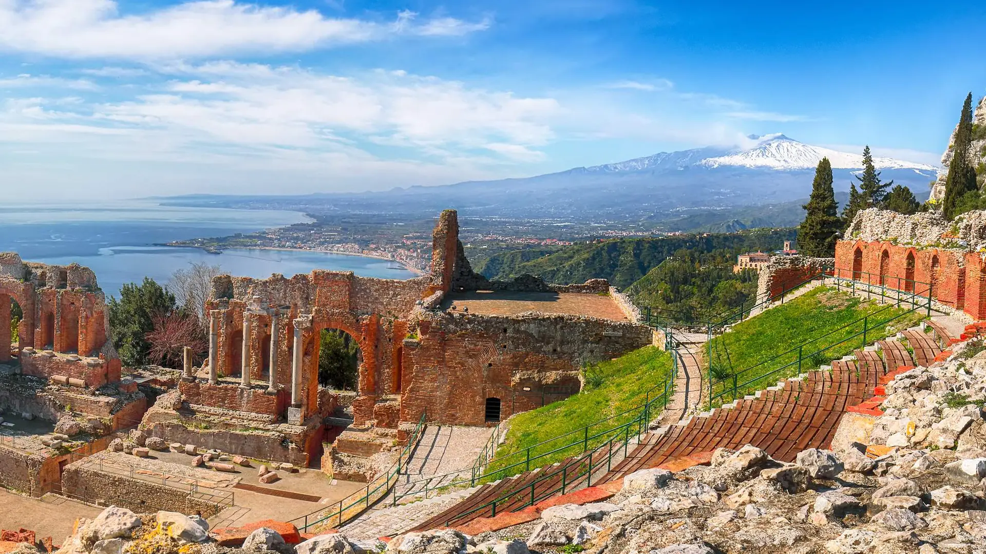 Ancient Greek theatre at Taormina with snow-capped Mount Etna beyond